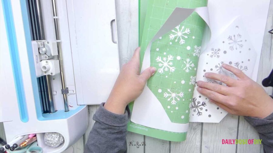 removing the cut tree in white cardstock from the cricut cut mat