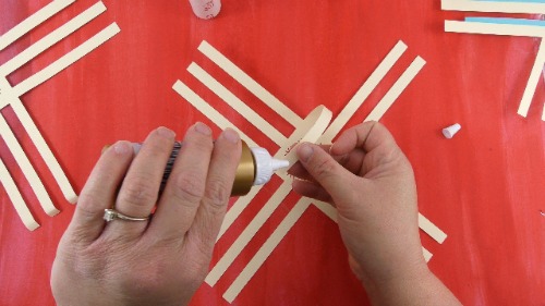 Use tacky glue to glue the ends of the 3D paper snowflake together