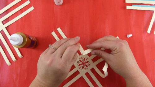glue the ends of the paper snowflake together