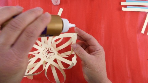 Glue the 2 sides of the paper snowflake together