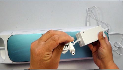 Plug the power cord into the back to set up your Cricut Machine