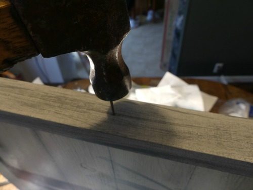 Hammer the wood frame into the side of the sign