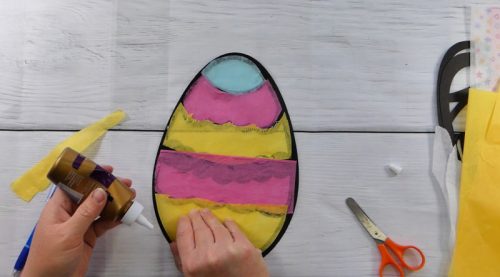 Glue Tissue paper to the back of easter egg suncatcher