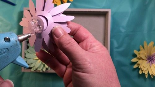 Putting together the paper daisies for a shadow box dispay