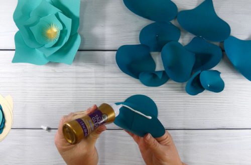 Glue the paper flower petals to the base