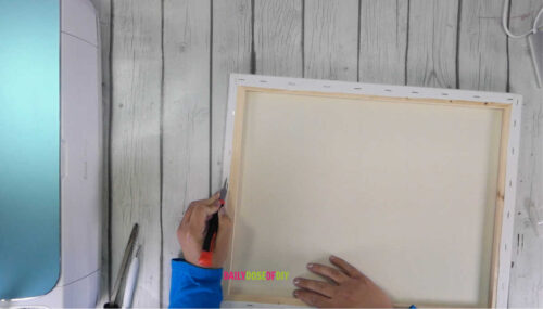 Cutting the canvas off of its frame with a utility knife
