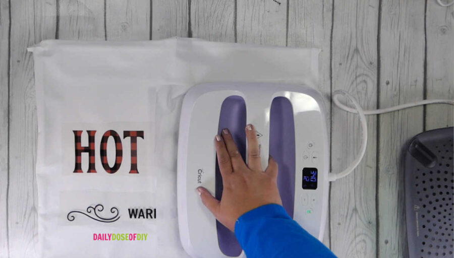 Heat press the vinyl onto the canvas to make a reverse canvas with HTV