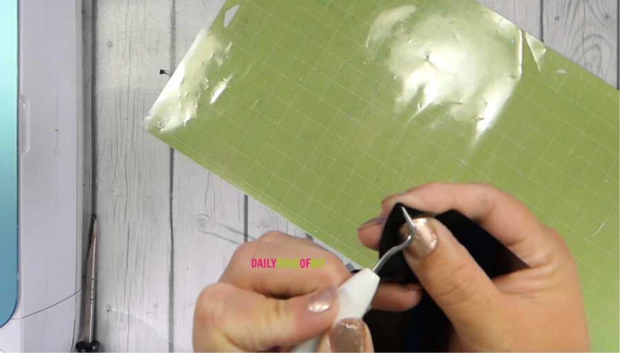 Poke the corner of your HTV to find out what side goes up on the cut mat