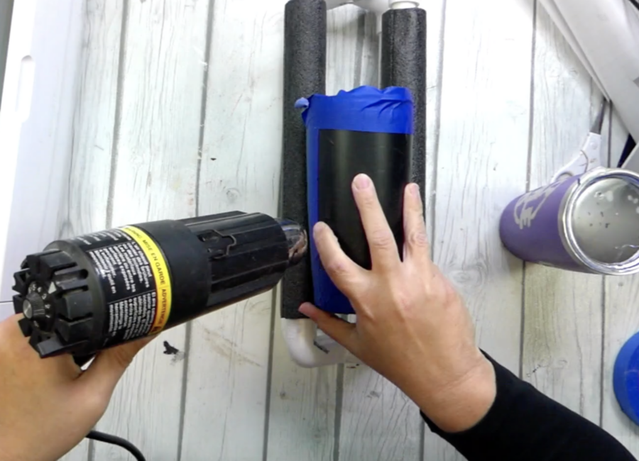 Useing a heat gun to wamr up the vinyl on the tumbler before applying Citristrip