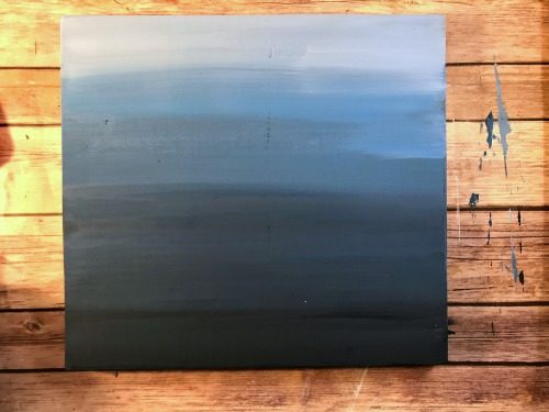 blending blue paints for an ombre painted sign