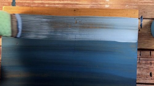 Blending the lightest shade of blue for an ombre painted sign.
