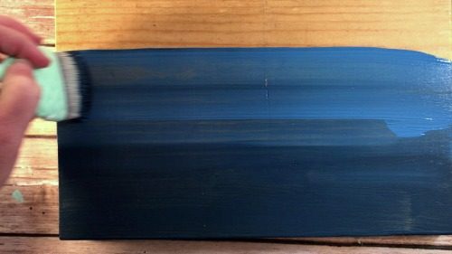Blending two shades of blue paint to make an ombre sign