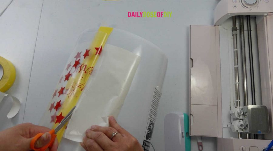 Remove one side of the backing from the vinyl transfer first to apply the decal to your light up camp bucket