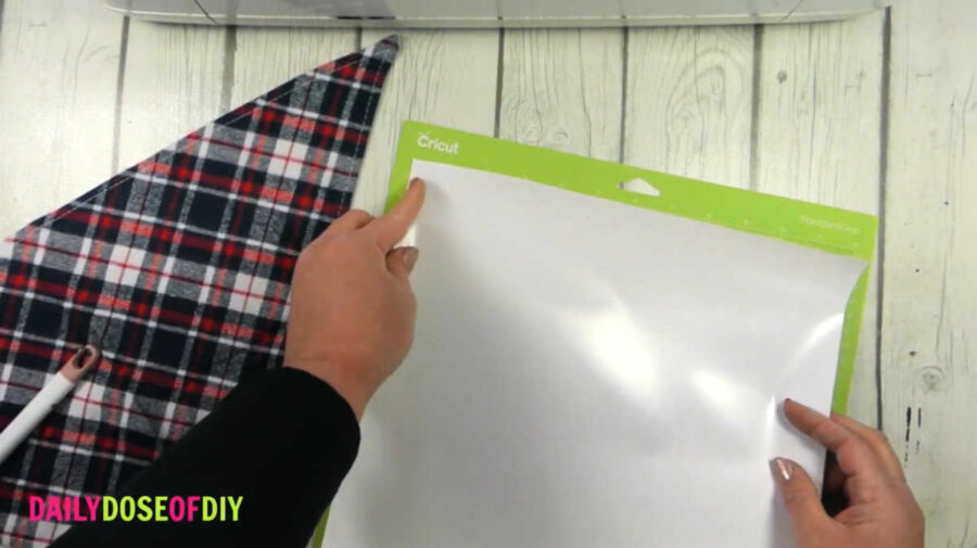 line your vinyl up to the top left corner of your mat and smooth it down