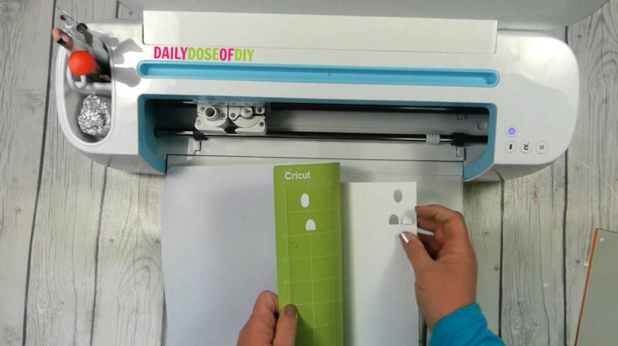 curling the mat away from the cardstock design to prevent curling of the paper design