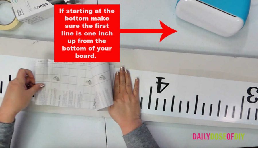 Lining up the vinyl ruler to apply it to the board