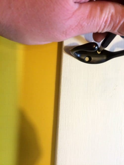lineing up the bronze coat hangers on the farm house sign