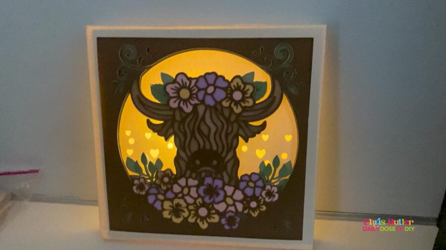 Layered highland cow paper craft with flowers and LED lights cut with a Cricut 