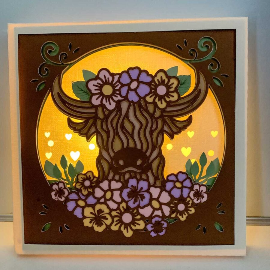 Layered highland cow 3d paper craft with purple, pink and yellow flowers 