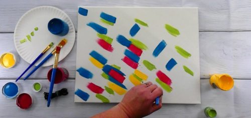 Using multiple colors of paint to paint a hot mess canvas