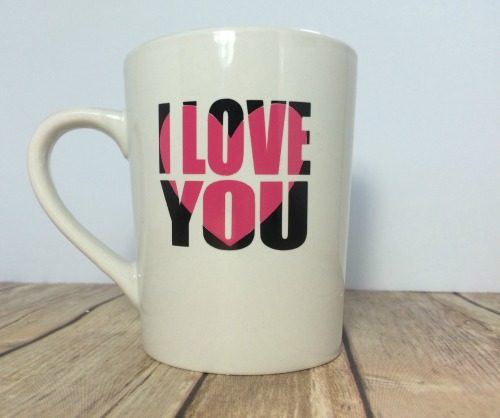 Adhesive vinyl knockout design applied to a coffee mug.
