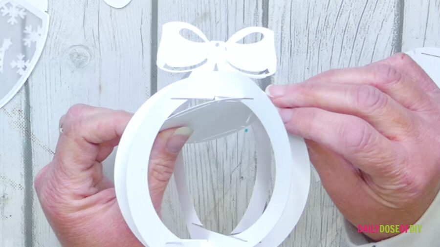 building the frame of the christmas ornament out of white cardstock 