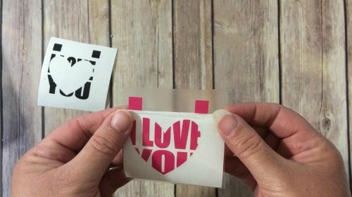Lining up two layers of adhesive vinyl for a knockout design