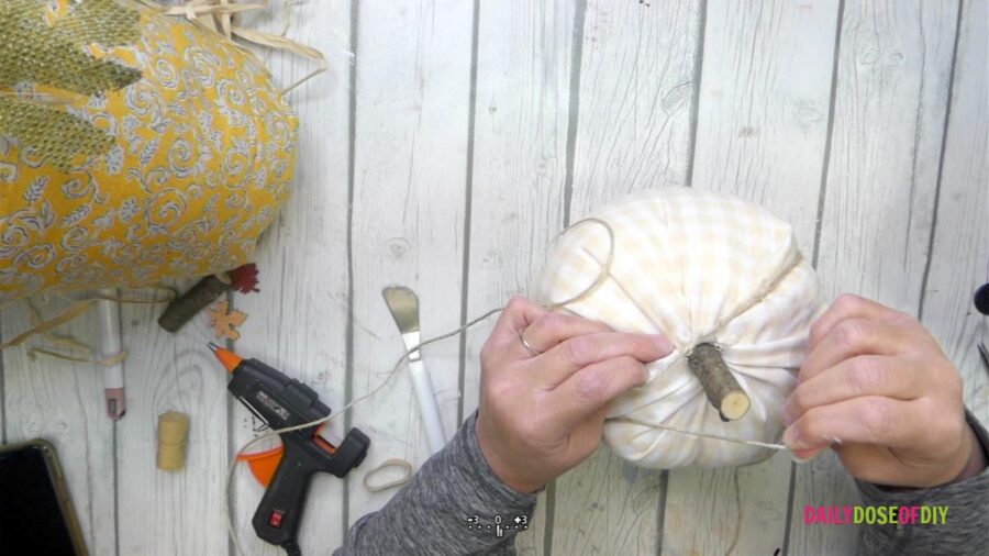 wrapping twine around the no sew fabric pumpkin 