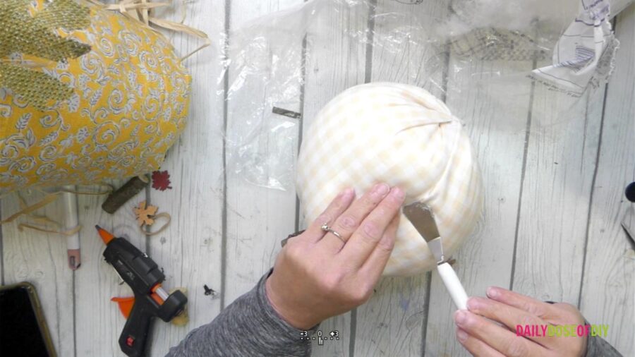 closing the seam on the side of the no sew fabric pumpkin 