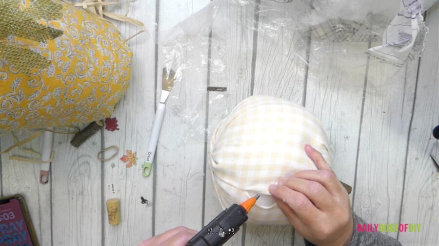 glue the seam of the DIY fabric pumpkin 