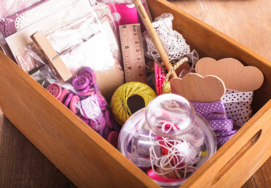 Scrapbooking craft materials organized in a wooden box