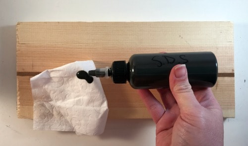 Place a squirt of paint on a baby wipe to stain a board in minutes