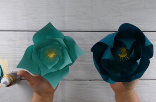 Paper flowers one with curled petals and one without curled petals 