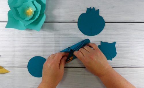 curling paper flower petals with a pencil for a paper flower display