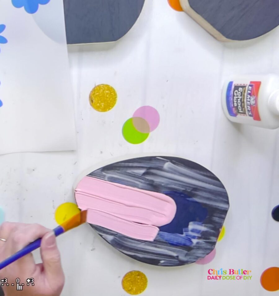 painting the top layer in light pink over the wooden egg 