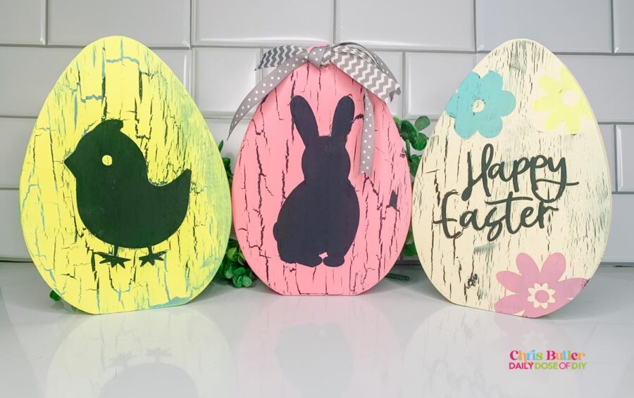 Three Wooded easter eggs painted three ways with cracle paint.  1 yellow egg, one pink egg and 1 creamy colored egg