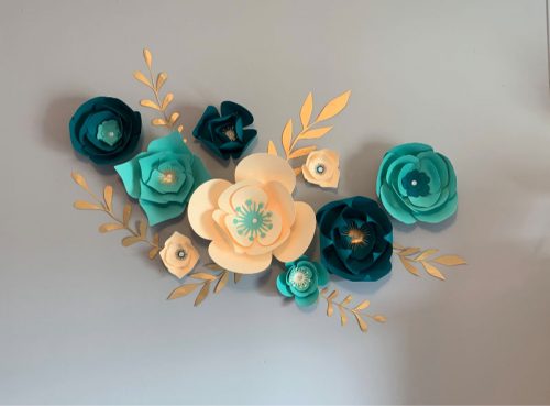 Teal and cream paper flowers used for a wall backdrop