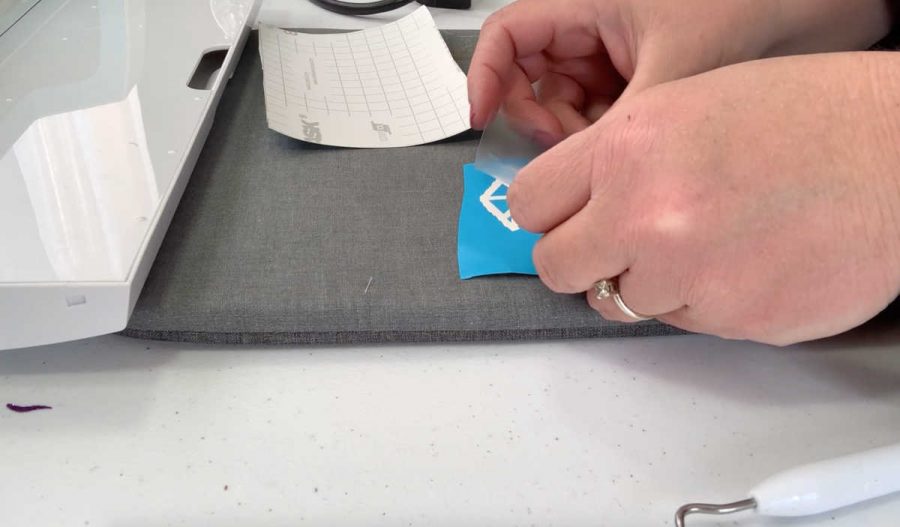 Add clear contact paper to transfer your stencil to the wood slice ornament