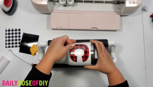 remove the transfer tape from the vinyl on the tumbler