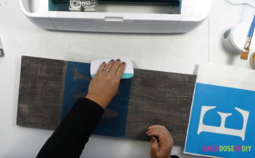 Burnish down the stencil to the vertical welcome sign
