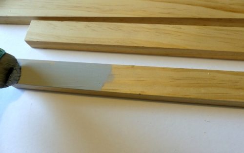 Painting the wood for the frame of a sign