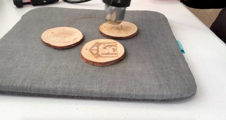 using a heat gun to make wood burn ornaments 