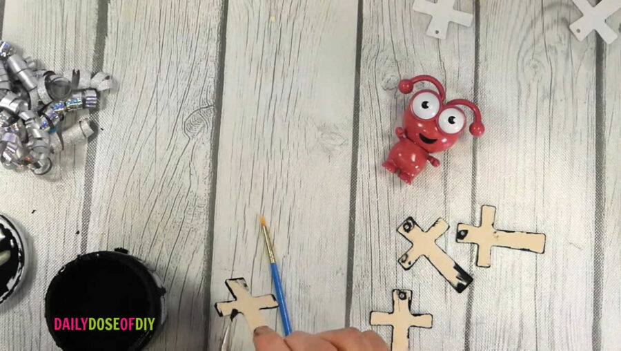 painting the edges of the wooden crosses